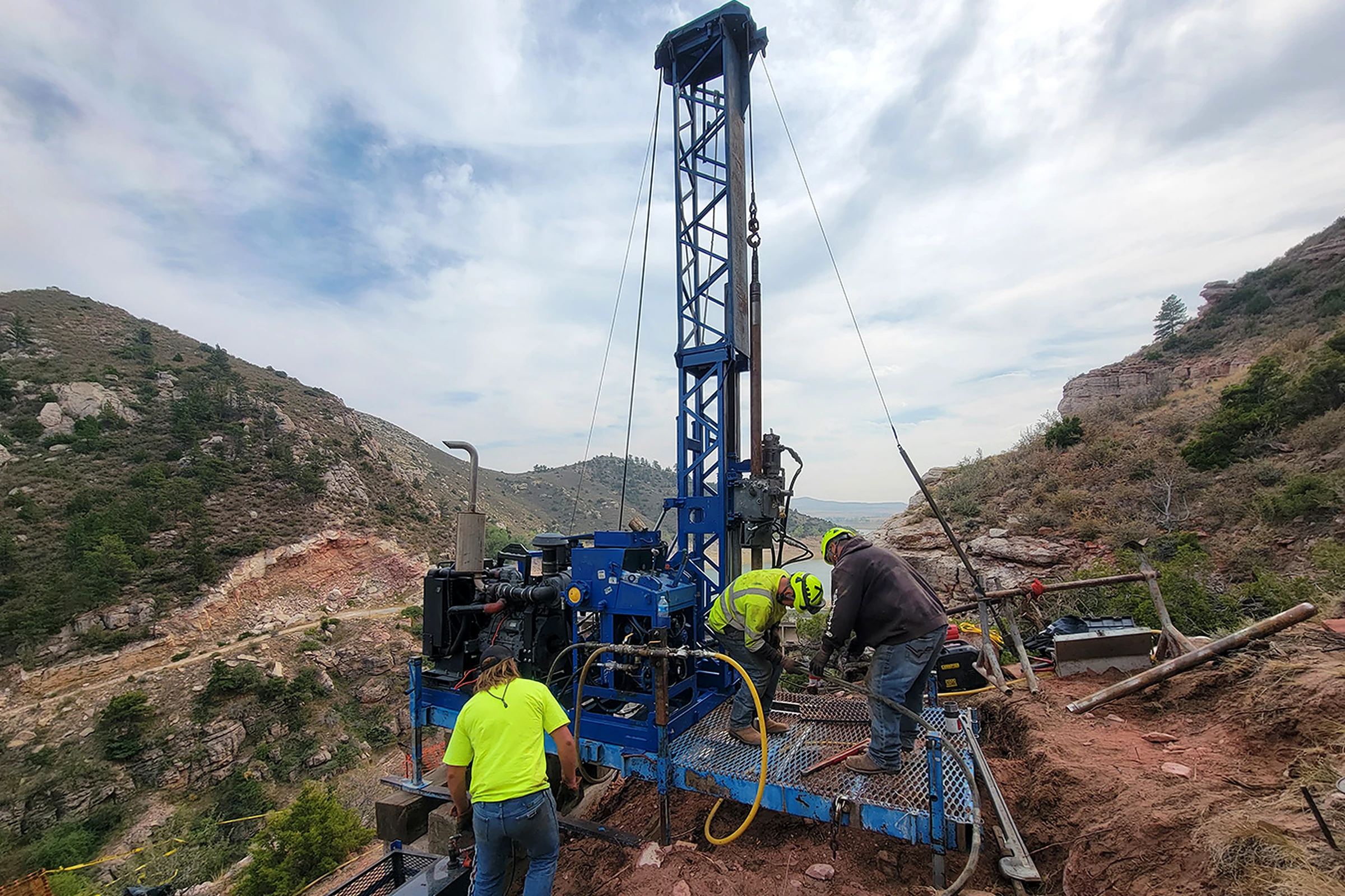 DA Smith crew operating a blue drilling rig on a canyon slope