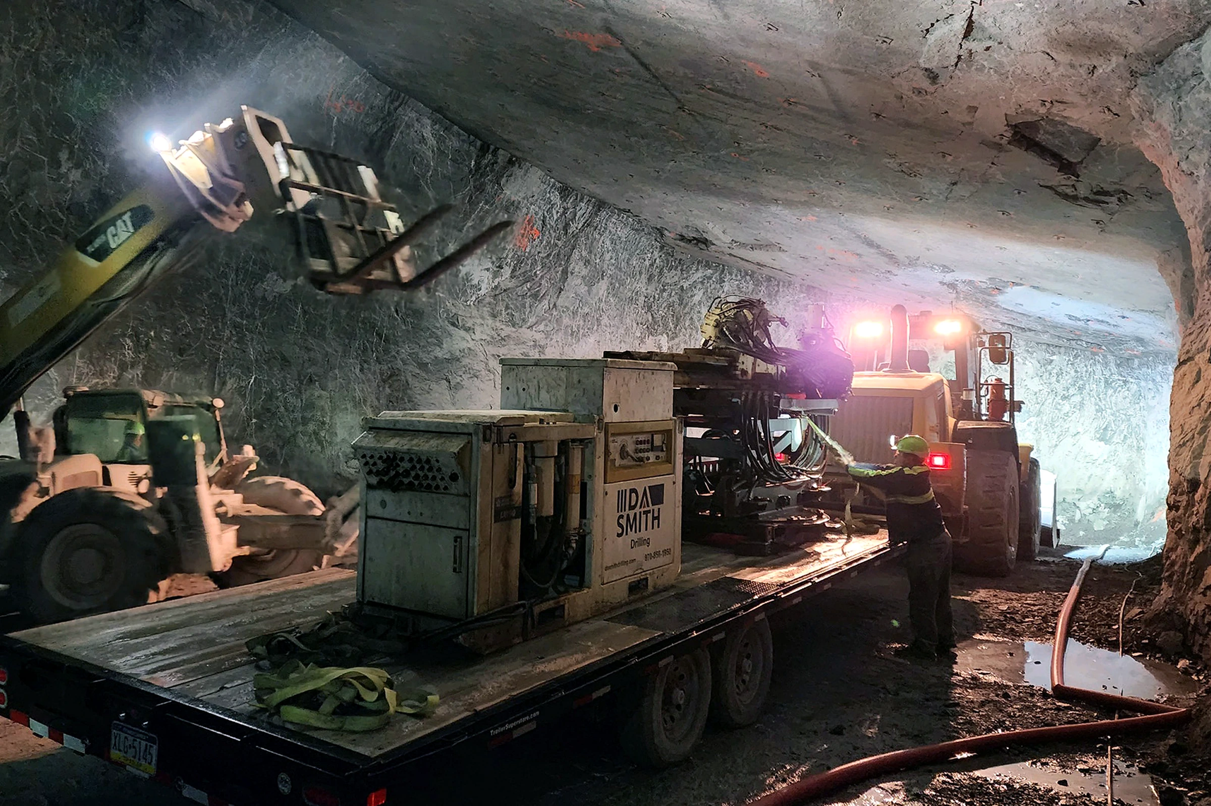 DA Smith drilling equipment on a trailer inside an underground excavation